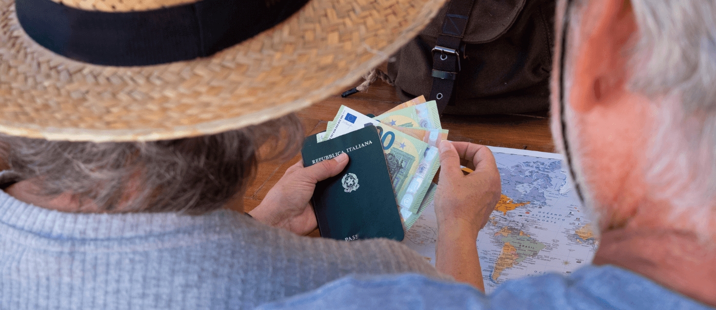 Older couple looking at plane tickets while thinking about their social security