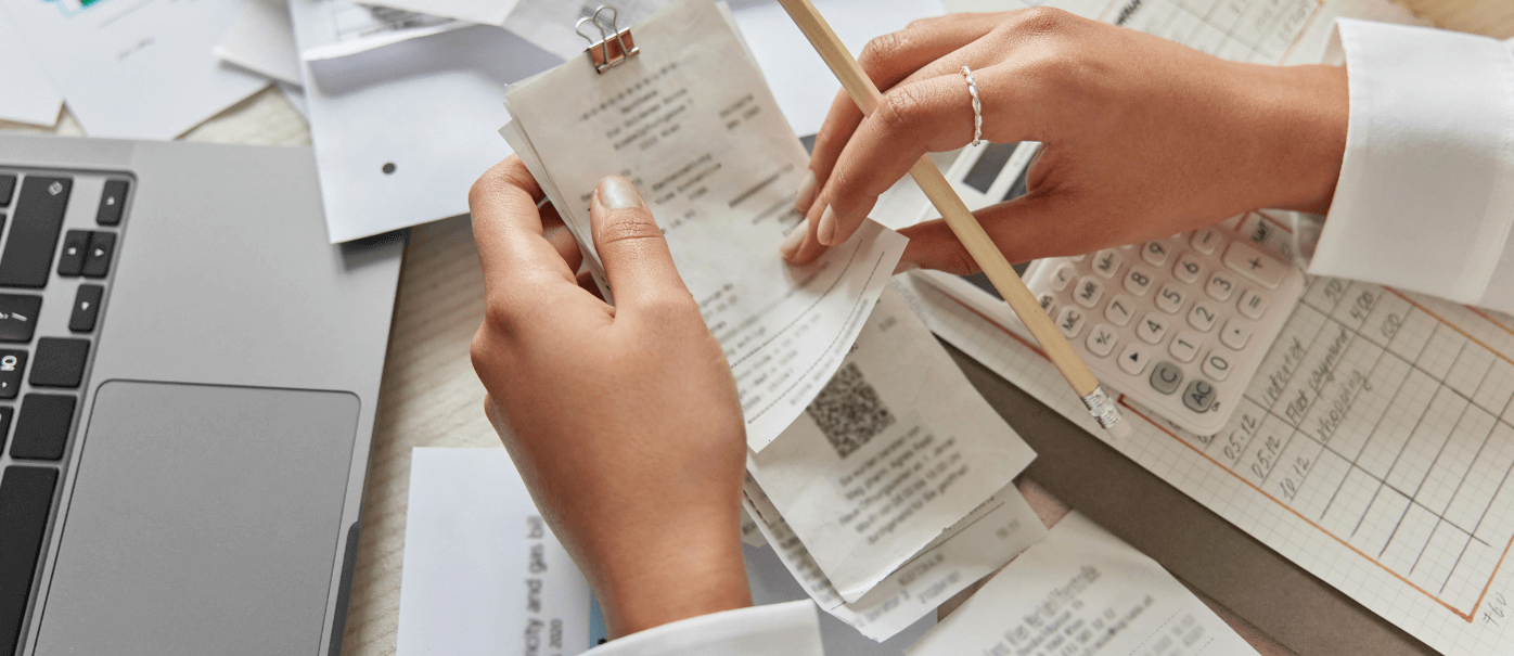 Hands holding contemporaneous records receipts for IRS deductions