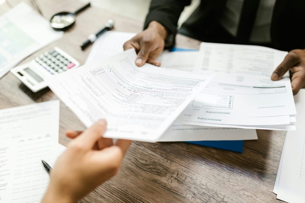 handing documents to individual across the table