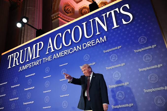 President Trump, standing in front of blue poster promoting new trump accounts.