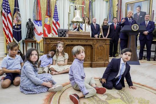 Kids ages 3-6 sitting on floor of the Oval Office with President Trump speaking about his new Trump Accounts