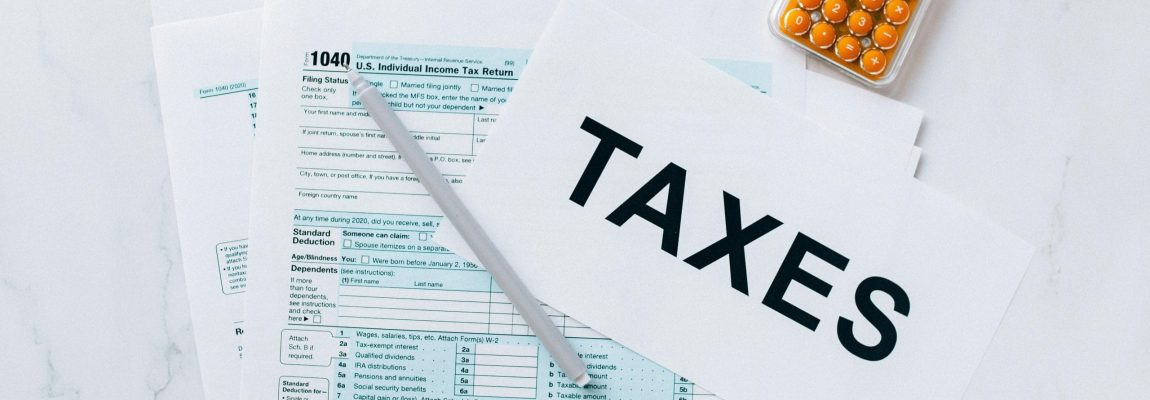 Tax Documents and Calculator on White Table