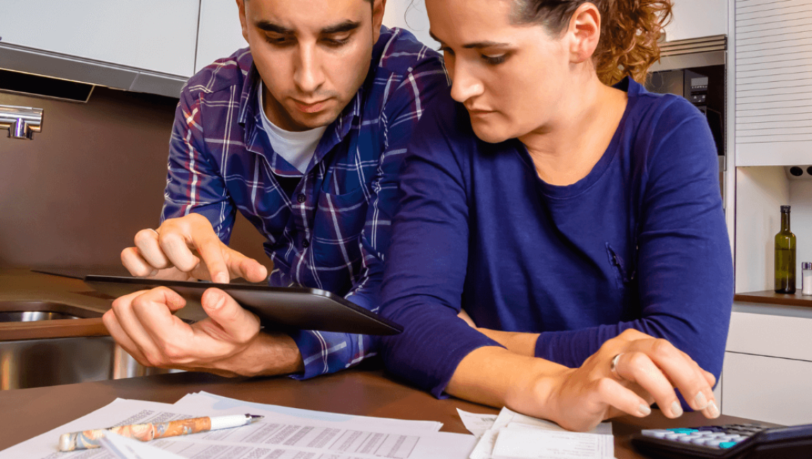 A couple looking at papers to increase their tax reduction