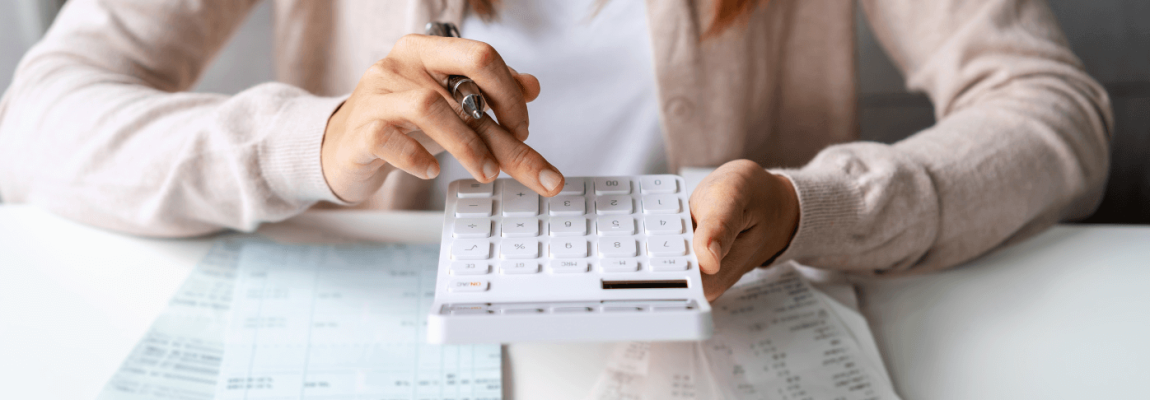 Woman on calculator working on tax basis