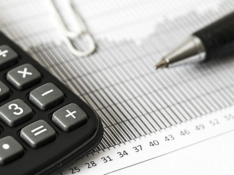 Calculator, pen and financial documents