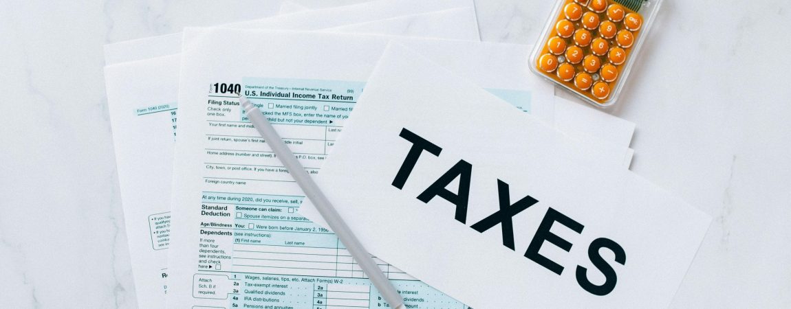 Tax papers and calculator on desk